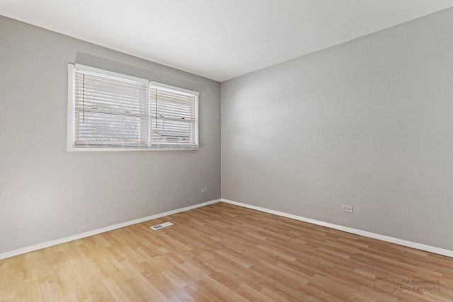 empty room with light hardwood / wood-style flooring