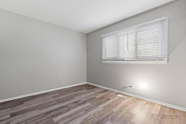 empty room with hardwood / wood-style flooring