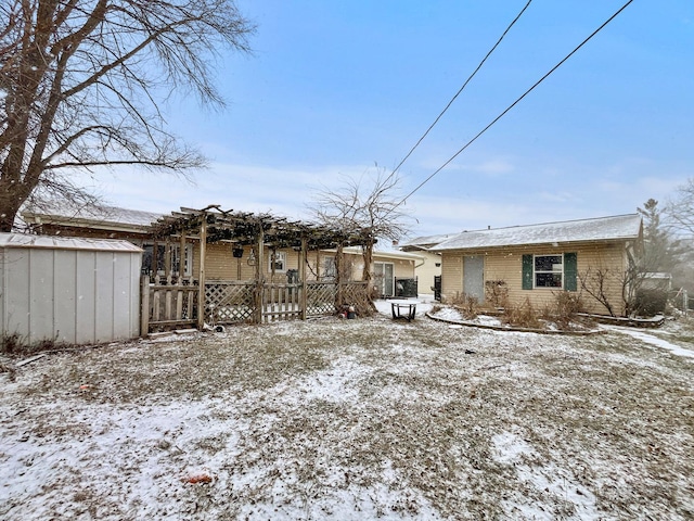 snow covered property featuring a storage unit