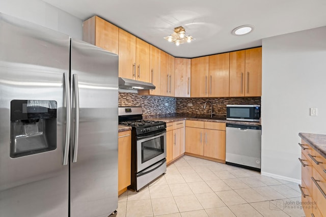 kitchen featuring light brown cabinetry, light tile patterned floors, and appliances with stainless steel finishes