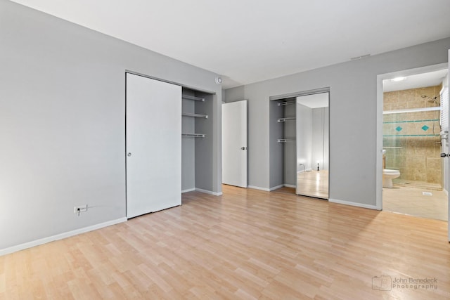 unfurnished bedroom featuring light hardwood / wood-style floors and connected bathroom