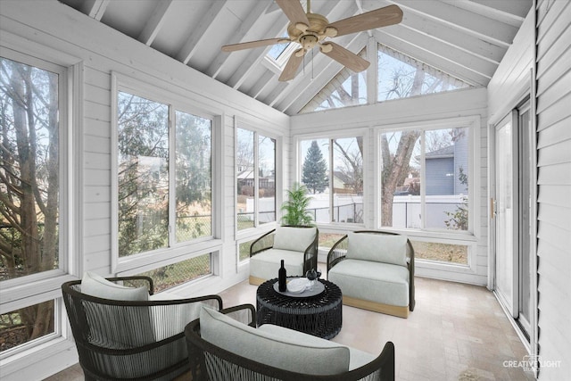 sunroom / solarium featuring ceiling fan and lofted ceiling with beams