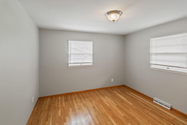 spare room featuring light hardwood / wood-style floors