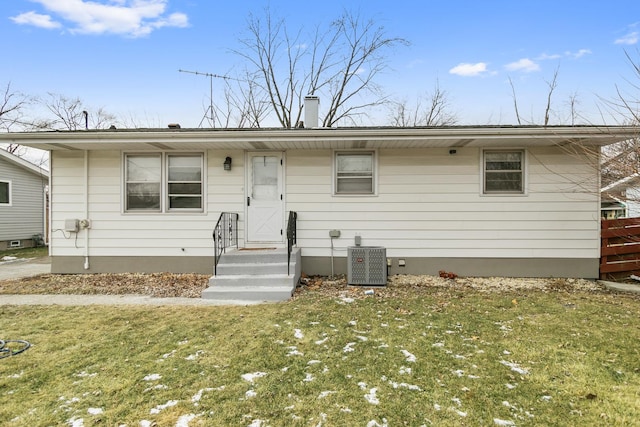 view of front of property featuring central AC and a front lawn