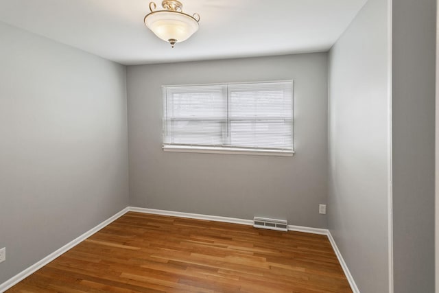 unfurnished room featuring wood-type flooring