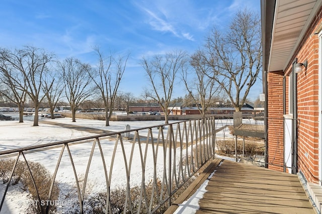 view of snow covered back of property