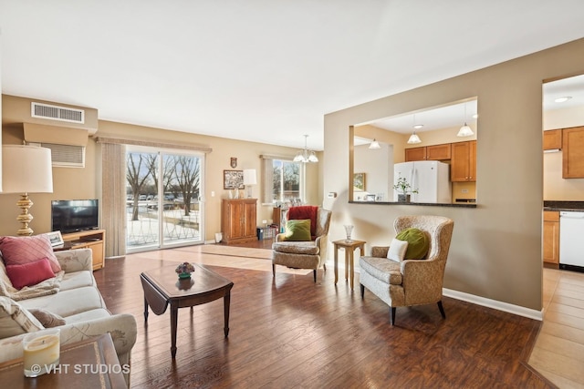 living room featuring hardwood / wood-style floors and a notable chandelier