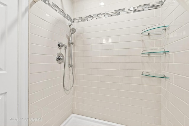 bathroom with tiled shower