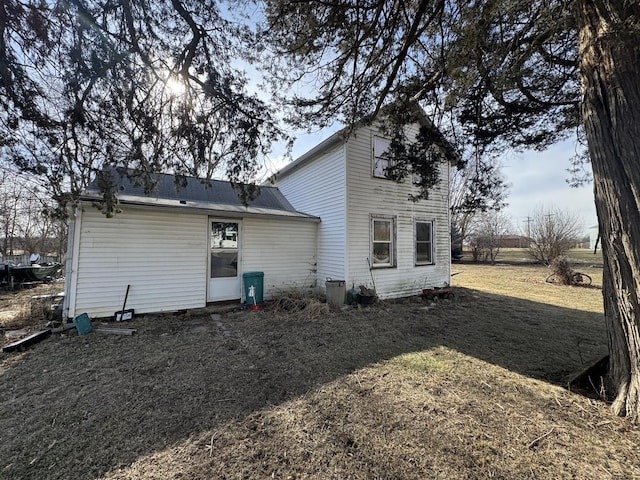 rear view of house with a yard