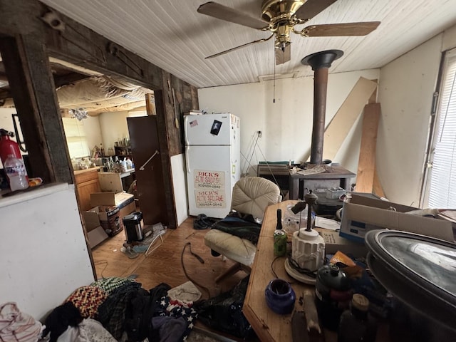 misc room featuring ceiling fan and a wood stove
