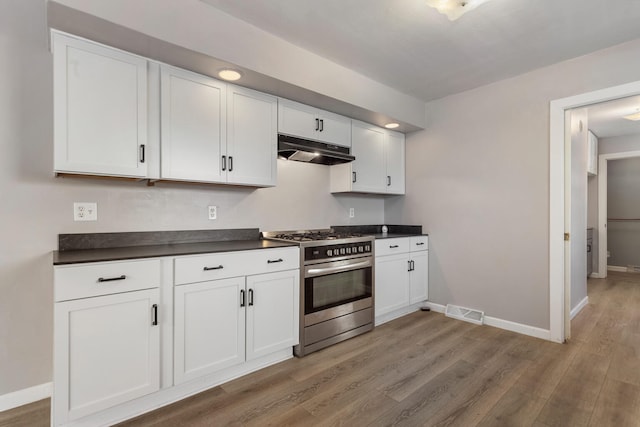 kitchen with white cabinetry, hardwood / wood-style flooring, and stainless steel range with gas stovetop