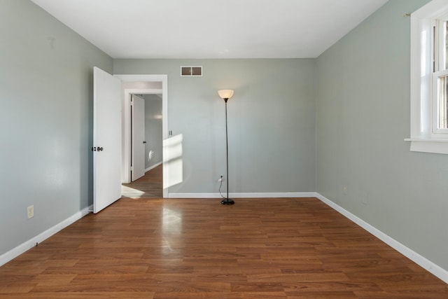 spare room featuring dark hardwood / wood-style floors