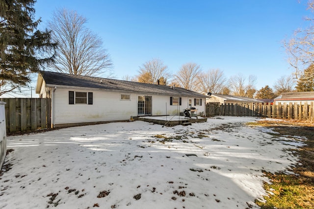 snow covered property with a wooden deck