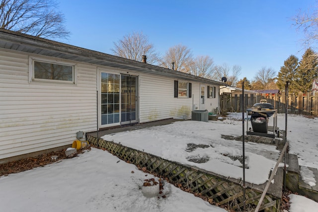 view of snow covered back of property