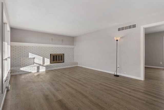 unfurnished living room featuring dark hardwood / wood-style flooring and a fireplace