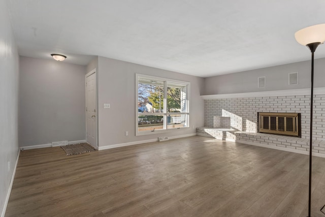 unfurnished living room with hardwood / wood-style floors and a fireplace