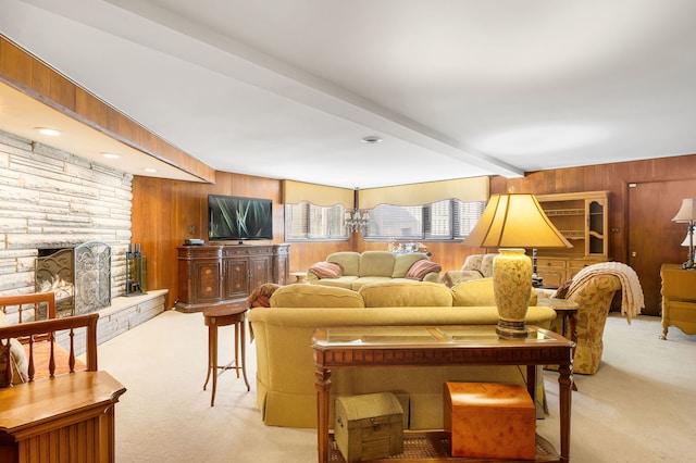 carpeted living room featuring beamed ceiling, wood walls, and a fireplace