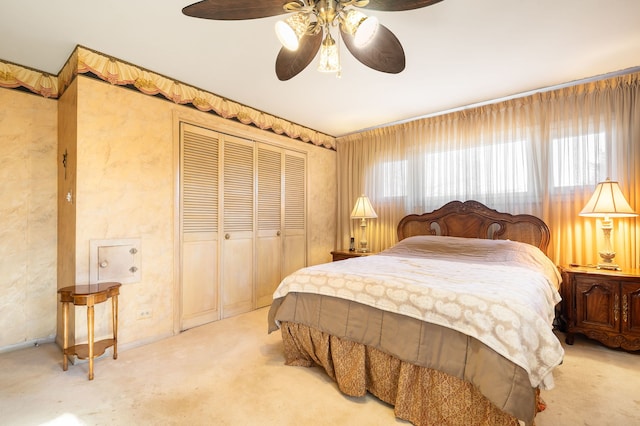 bedroom with light carpet, a closet, and ceiling fan