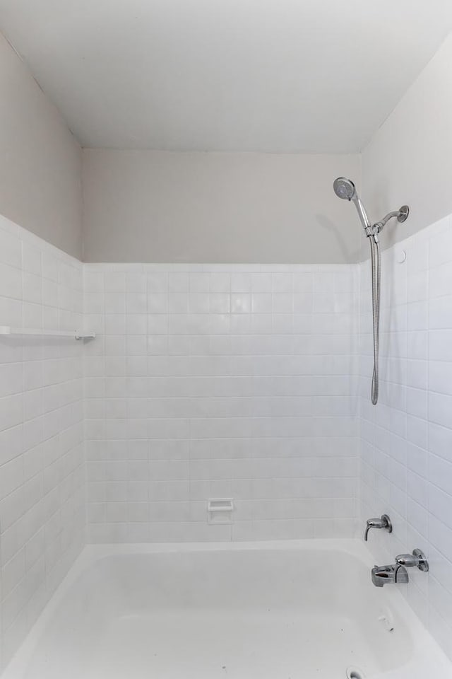 bathroom with bathing tub / shower combination