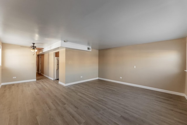 empty room with wood-type flooring and ceiling fan