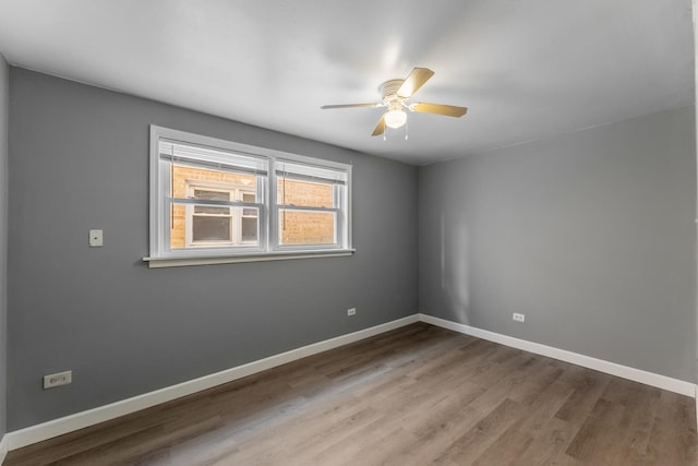 empty room featuring wood-type flooring and ceiling fan