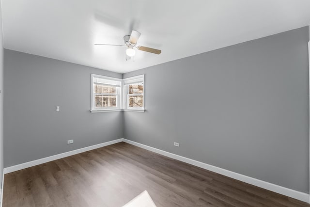 spare room featuring dark hardwood / wood-style floors and ceiling fan