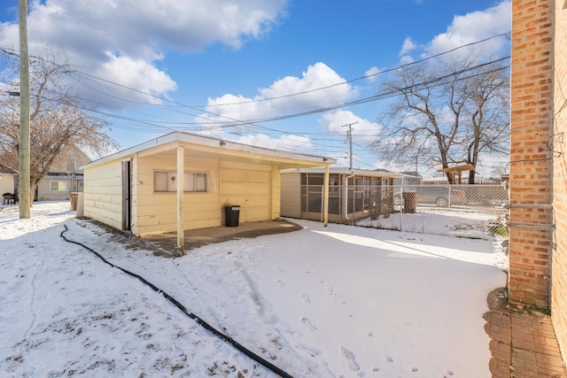 view of snow covered rear of property