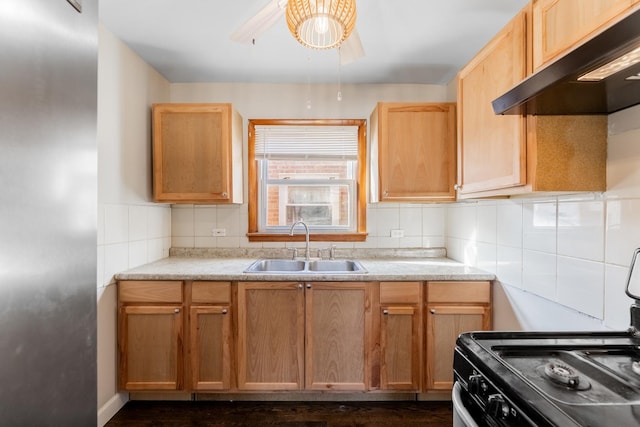 kitchen featuring exhaust hood, sink, decorative backsplash, and black gas stove