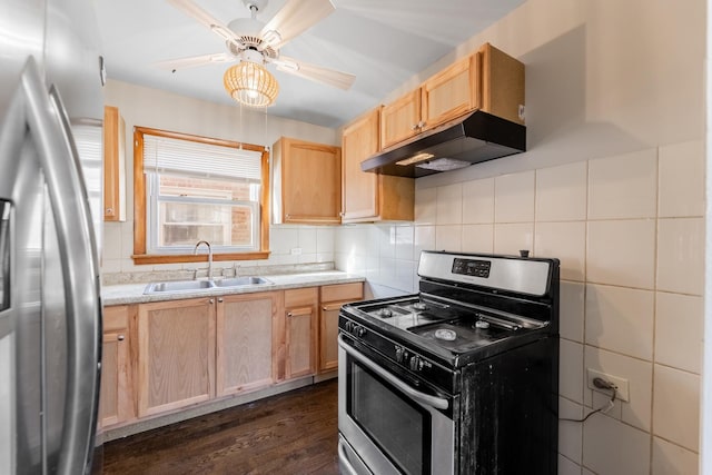 kitchen with light brown cabinetry, sink, light stone counters, dark hardwood / wood-style floors, and stainless steel appliances