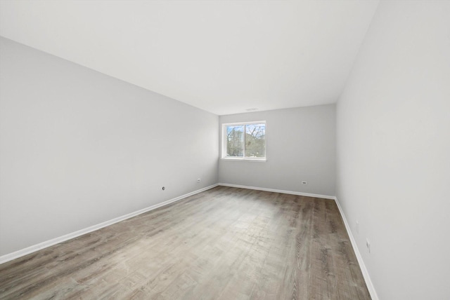 empty room with hardwood / wood-style flooring