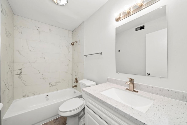 full bathroom featuring vanity, toilet, hardwood / wood-style flooring, and tiled shower / bath combo