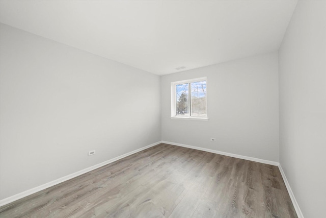 empty room with light hardwood / wood-style flooring