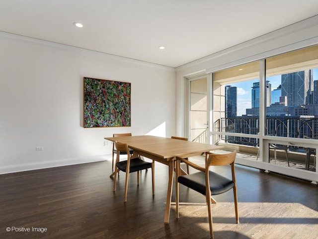 dining room with dark hardwood / wood-style flooring and ornamental molding