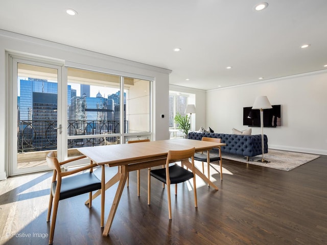 dining room with dark wood-type flooring and ornamental molding