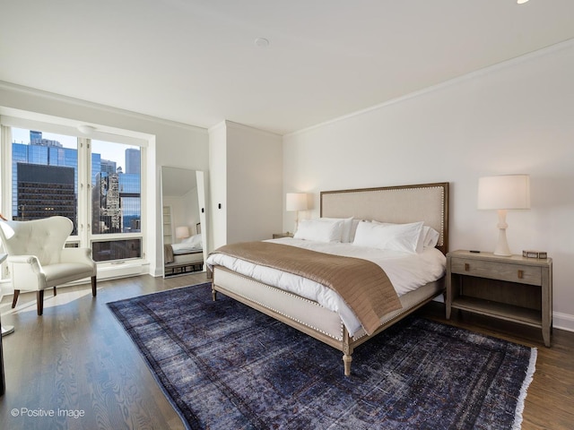 bedroom featuring dark wood-type flooring and crown molding