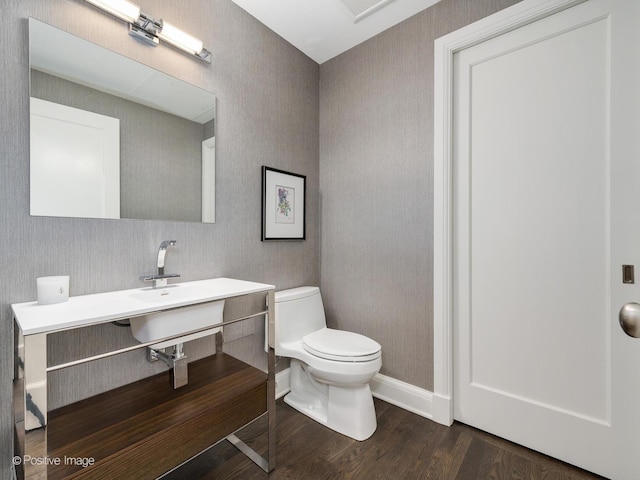 bathroom featuring wood-type flooring and toilet