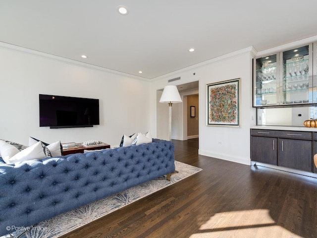 living room with dark wood-type flooring and ornamental molding