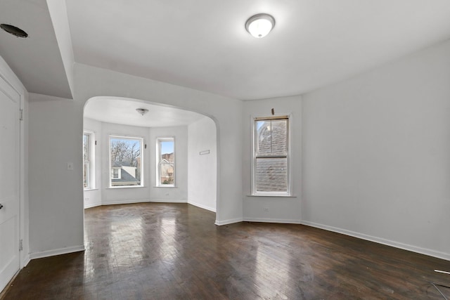 unfurnished room with dark hardwood / wood-style flooring