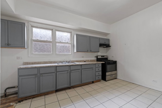 kitchen with sink, stainless steel range with gas stovetop, and gray cabinetry