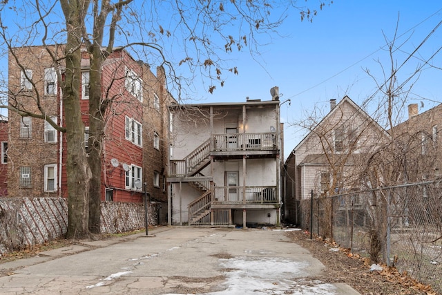 rear view of property featuring covered porch