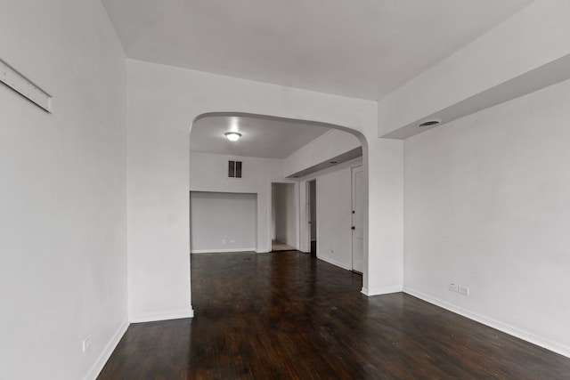 spare room featuring dark wood-type flooring