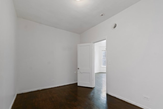 spare room with dark hardwood / wood-style flooring