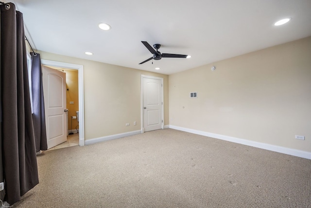 unfurnished bedroom featuring light colored carpet, ceiling fan, and ensuite bathroom