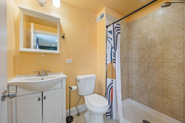 bathroom with a shower with curtain, vanity, tile patterned floors, and toilet