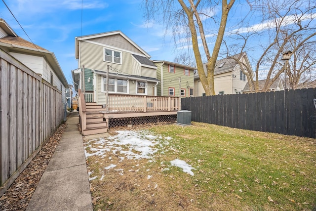 rear view of house featuring a yard and a deck