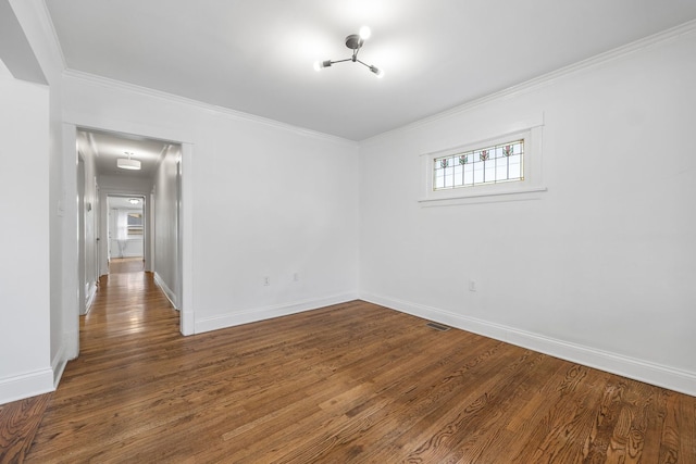 empty room featuring hardwood / wood-style flooring and ornamental molding