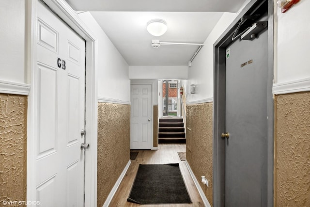 corridor with light hardwood / wood-style flooring