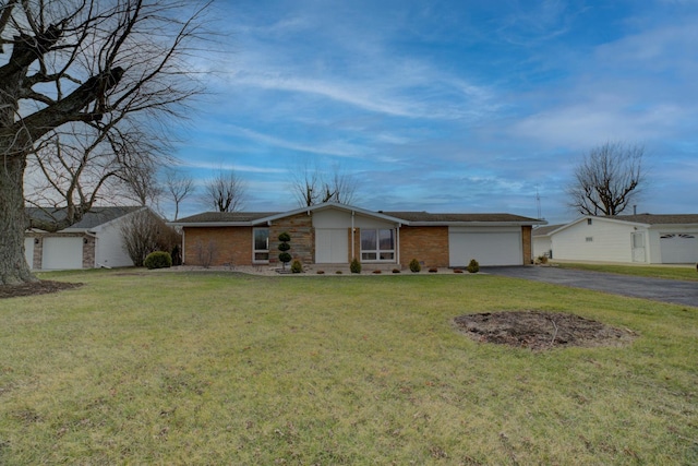 ranch-style home with a front yard and a garage