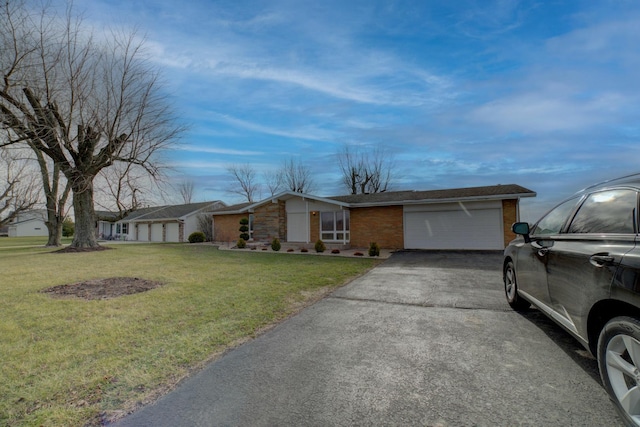 ranch-style home featuring a garage and a front lawn