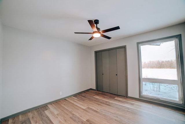 unfurnished bedroom featuring ceiling fan and light hardwood / wood-style floors